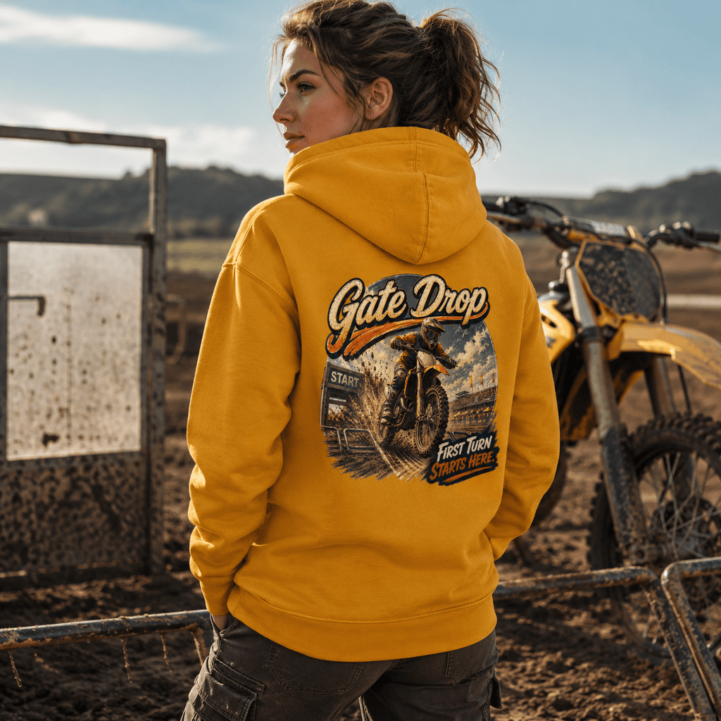 Model wearing the Camberline Riders Gate Drop Motocross Hoodie – Mustard, showing the Riders back graphic in a motorcycle-inspired setting