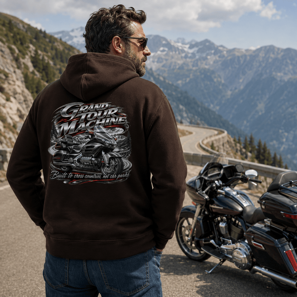 Model wearing the Camberline Riders Grand Tour Machine Touring Motorcycle Hoodie – Hot Chocolate, showing the Camberline Riders graphic in a motorcycle-inspired setting