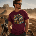 Model wearing the Camberline Riders Jump Face Motocross Dirt Bike T-Shirt – Burgundy, showing the Camberline Riders graphic in a motorcycle-inspired setting
