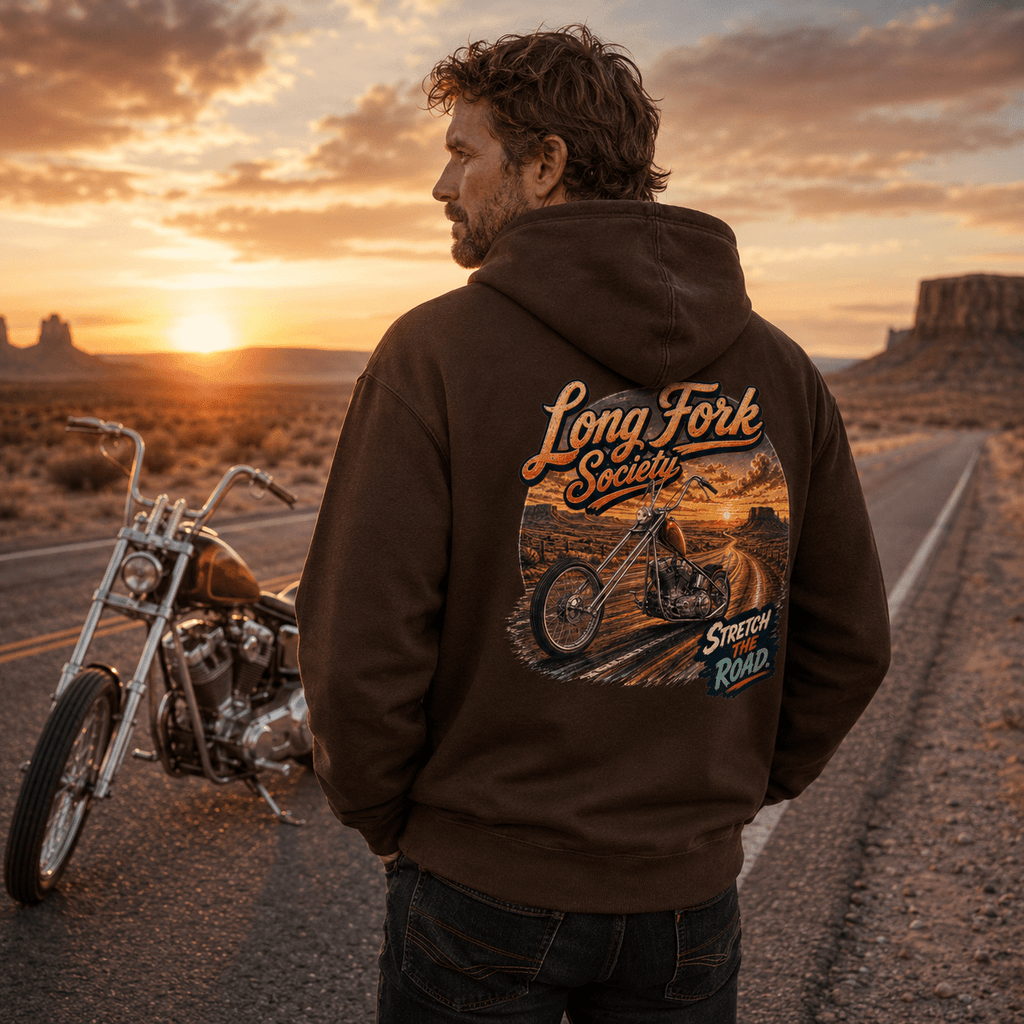 Model wearing the Camberline Riders Long Fork Society Chopper Motorcycle Hoodie – Hot Chocolate, showing the Camberline Riders graphic in a motorcycle-inspired setting