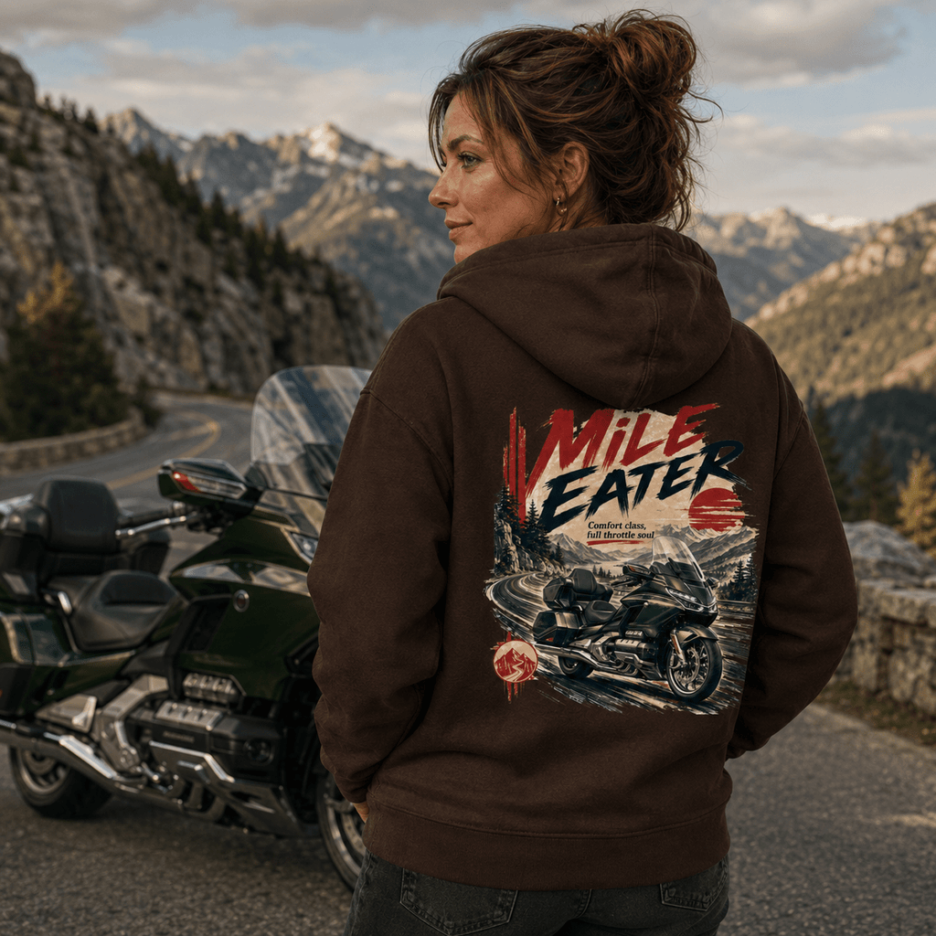 Model wearing the Camberline Riders Mile Eater Luxury Touring Motorcycle Hoodie – Hot Chocolate, showing the Camberline Riders graphic in a motorcycle-inspired setting