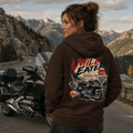 Model wearing the Camberline Riders Mile Eater Luxury Touring Motorcycle Hoodie – Hot Chocolate, showing the Camberline Riders graphic in a motorcycle-inspired setting