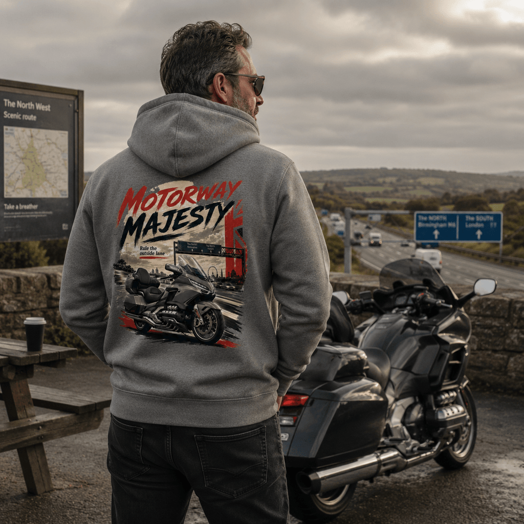 Model wearing the Camberline Riders Motorway Majesty Heavy Tourer Hoodie – Charcoal, showing the Camberline Riders graphic in a motorcycle-inspired setting