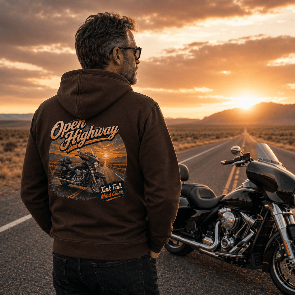 Model wearing the Camberline Riders Open Highway Touring Motorcycle Hoodie – Hot Chocolate, showing the Camberline Riders graphic in a motorcycle-inspired setting