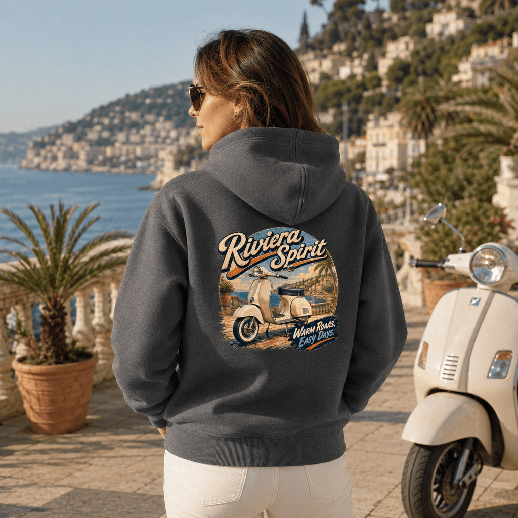 Model wearing the Camberline Riders Riviera Spirit Retro Scooter Hoodie – Charcoal, showing the Camberline Riders graphic in a motorcycle-inspired setting