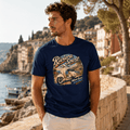 Model wearing the Camberline Riders Riviera Spirit Retro Scooter T-Shirt – Navy, showing the Camberline Riders graphic in a motorcycle-inspired setting