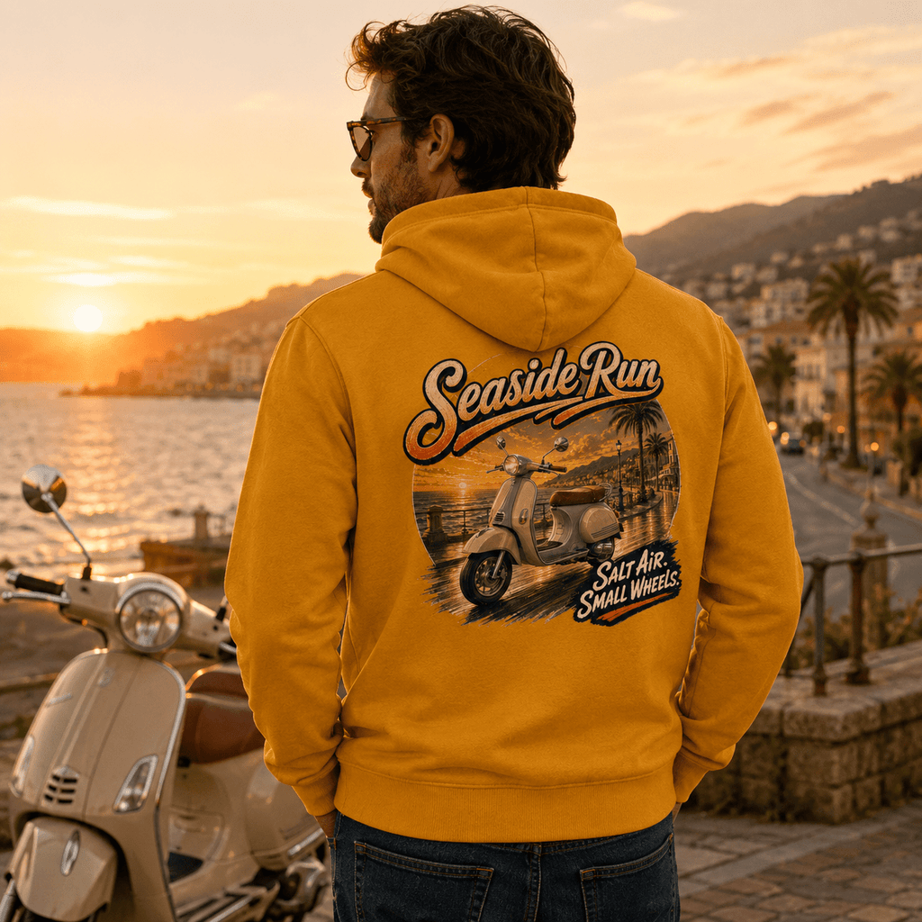 Model wearing the Camberline Riders Seaside Run Classic Scooter Hoodie – Mustard, showing the Camberline Riders graphic in a motorcycle-inspired setting