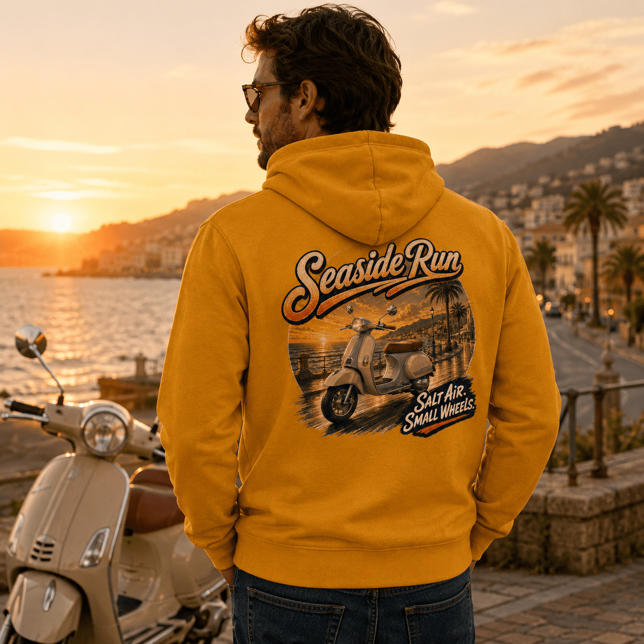 Model wearing the Camberline Riders Seaside Run Classic Scooter Hoodie – Mustard, showing the Camberline Riders graphic in a motorcycle-inspired setting