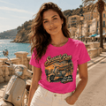 Model wearing the Camberline Riders Seaside Run Classic Scooter T-Shirt – Hot Pink, showing the Camberline Riders graphic in a motorcycle-inspired setting
