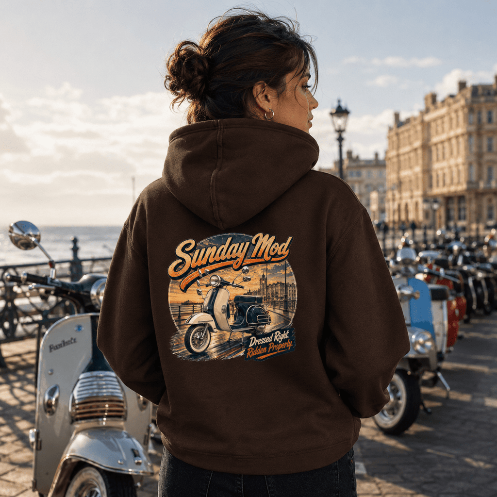 Model wearing the Camberline Riders Sunday Mod Classic Scooter Hoodie – Hot Chocolate, showing the Camberline Riders graphic in a motorcycle-inspired setting