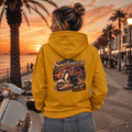 Model wearing the Camberline Riders Sunset Scooter Club Vintage Scooter Hoodie – Mustard, showing the Camberline Riders graphic in a motorcycle-inspired setting