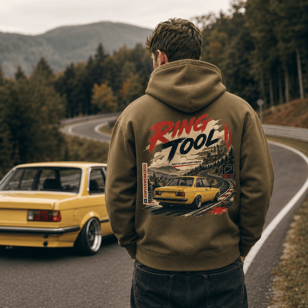 Model wearing Camberline Cars Ring Tool Nürburgring Built To Carve Every Corner Yellow Hoodie in Combat Green