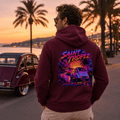 Model wearing Camberline Cars Saint Tropez Coastline Dreams Sunset Machine Retro Hoodie in Burgundy