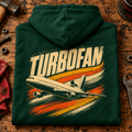 Turbofan Trijet Airliner hoodie in Bottle Green, folded on a workshop bench, showing the back print