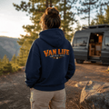 Camberline Van Life Camp Drive Repeat navy hoodie worn by female model at mountain viewpoint with converted campervan in background