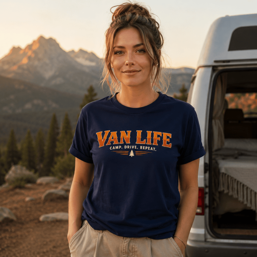 Camberline Van Life Camp Drive Repeat navy t-shirt worn by female model at mountain viewpoint with campervan in background