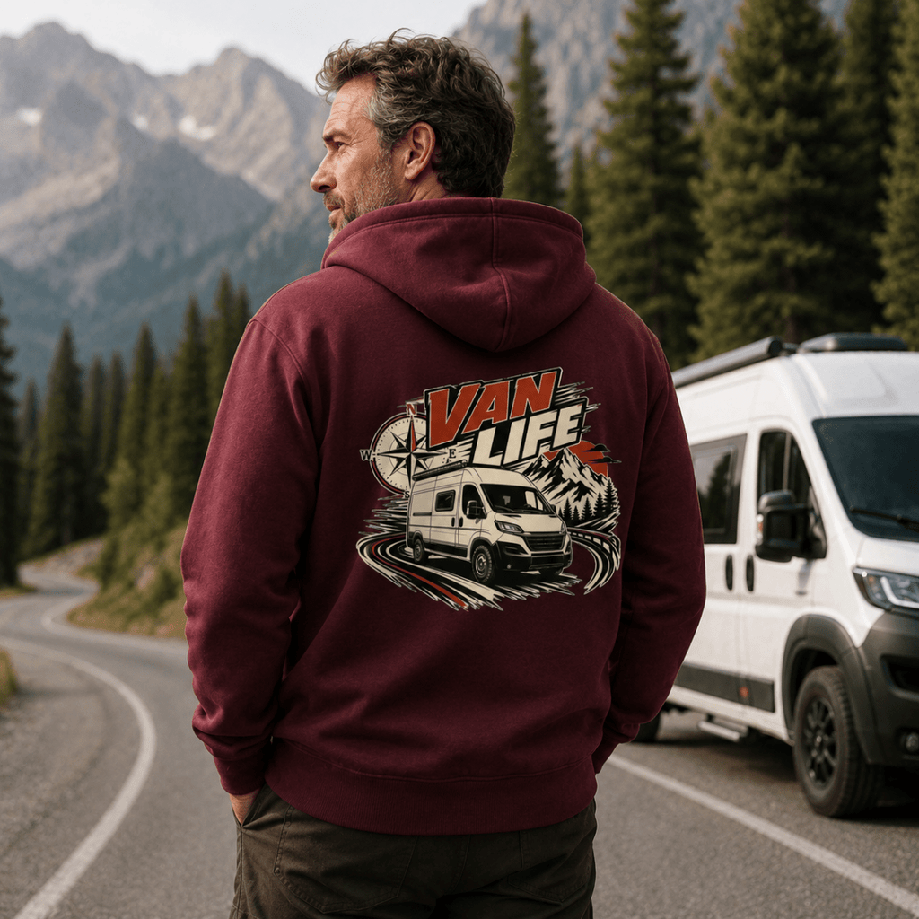 Model wearing Camberline burgundy van life hoodie showing Van Life compass and modern high-roof van on mountain road graphic on back