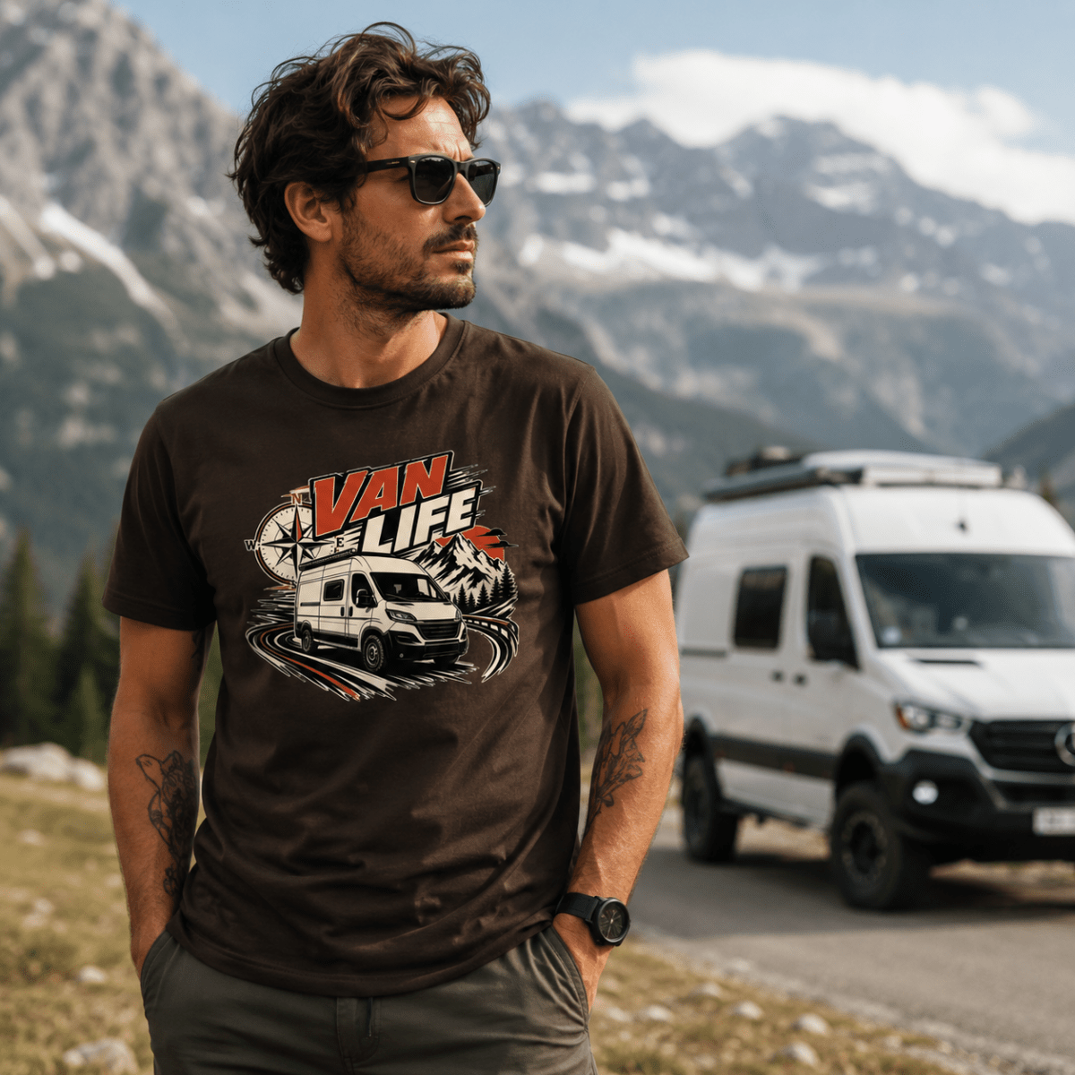 Model wearing Camberline chocolate brown van life t-shirt showing Van Life compass with high-roof modern van on mountain road on chest