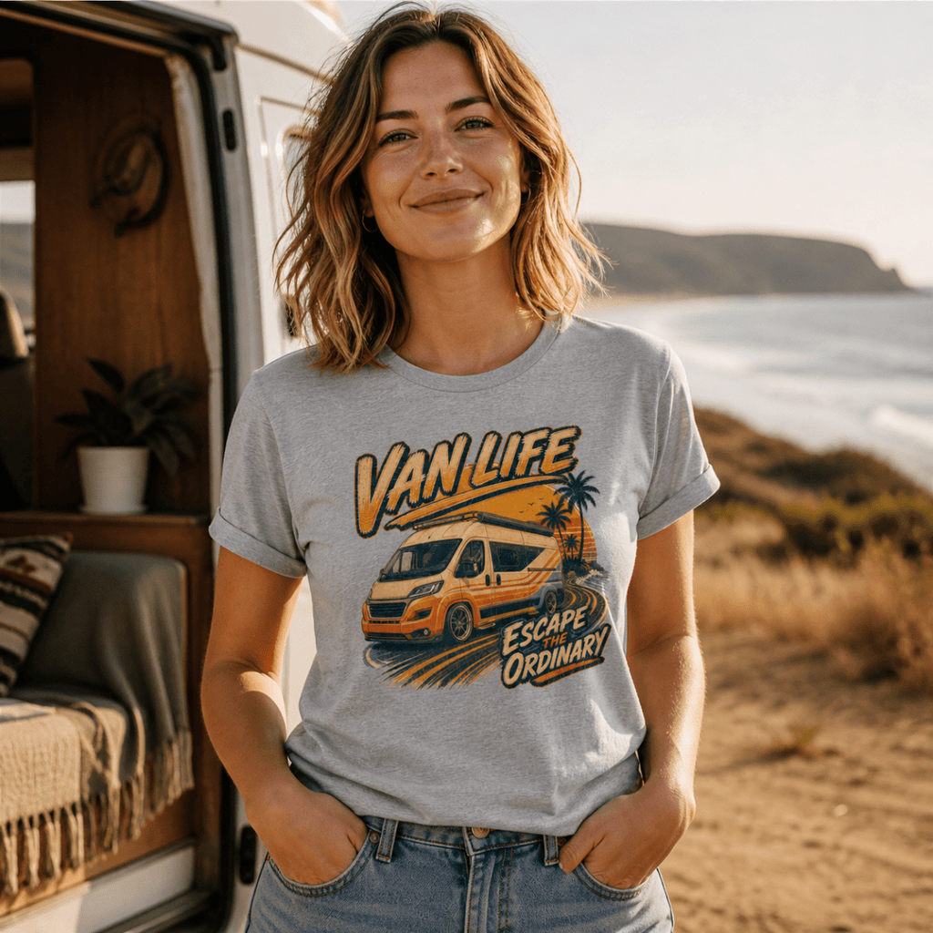 Woman wearing a 'Van Life Escape Ordinary' t-shirt by a van in a scenic outdoor setting.