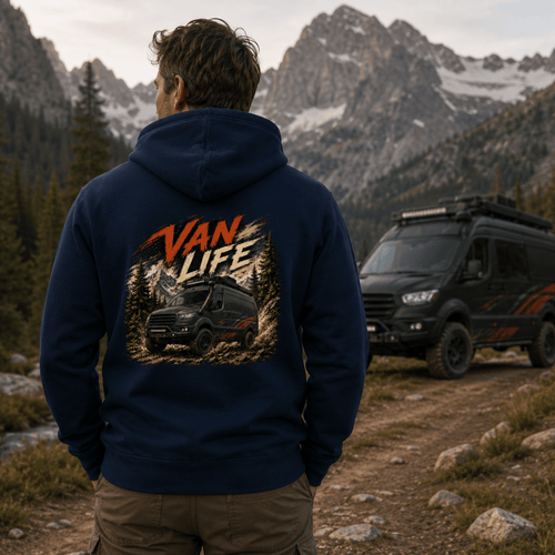 Person wearing a hoodie with 'Van Life' design in a mountainous landscape with a van.