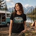 Model wearing Camberline black van life t-shirt showing Van Life Lakeside Escape vintage retro campervan lake and mountain camping badge on chest