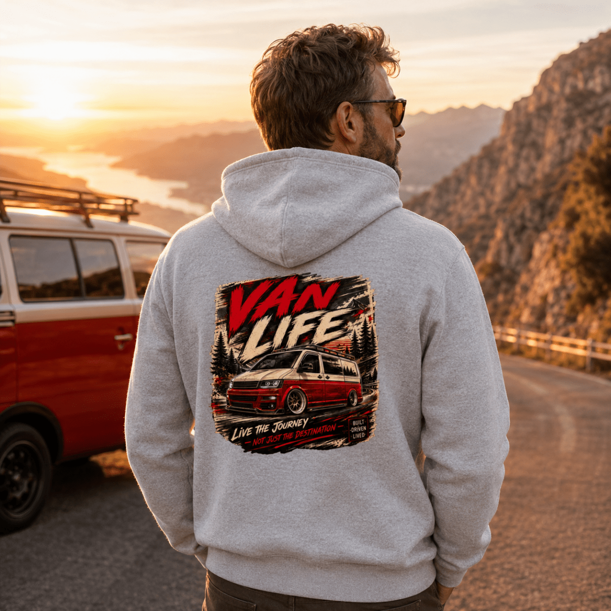 Model wearing Camberline grey marl van life hoodie showing Van Life Live the Journey red and cream two-tone van and mountain graphic on back