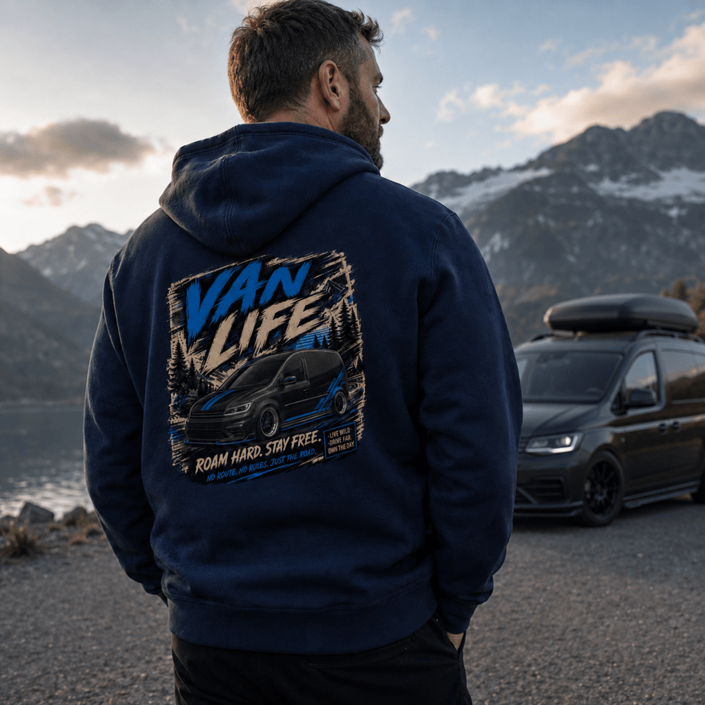 Model wearing Camberline navy van life hoodie showing Van Life Roam Hard Stay Free black and blue van and mountain pine graphic on back