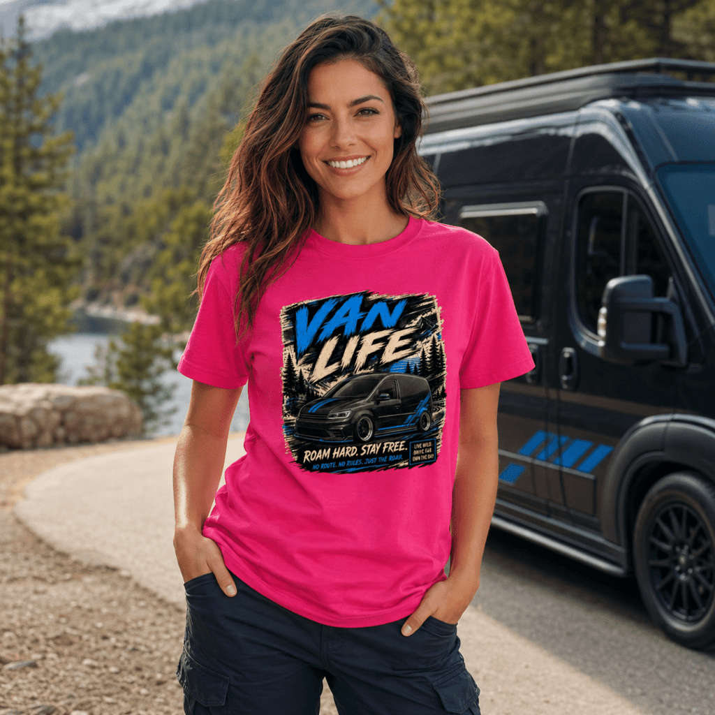 Woman wearing a pink 'Van Life' t-shirt standing in front of a van with a scenic background.
