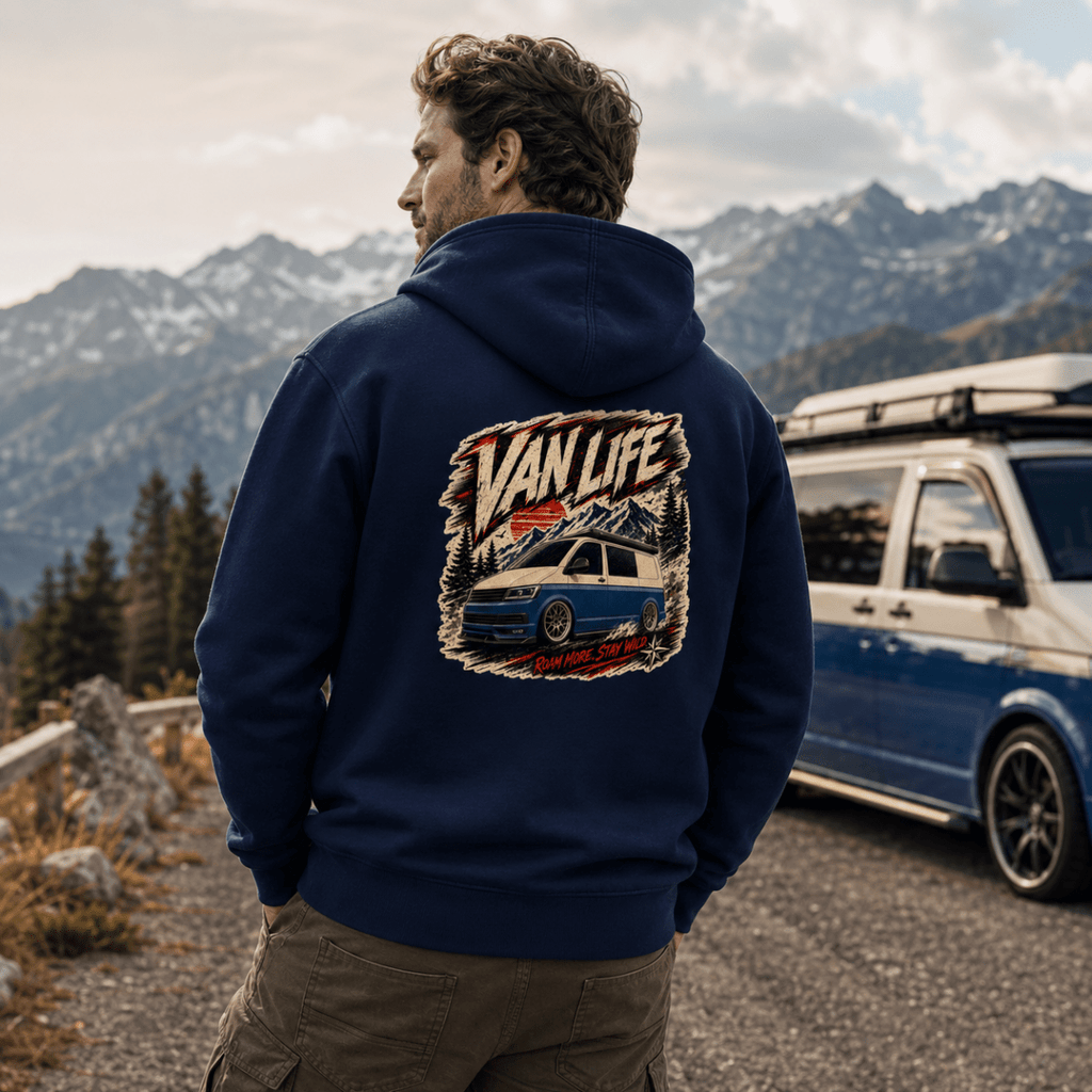 Model wearing Camberline navy van life hoodie showing Van Life Roam More Stay Wild blue two-tone campervan and mountain graphic on back