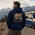 Model wearing Camberline navy van life hoodie showing Van Life Roam More Stay Wild blue two-tone campervan and mountain graphic on back