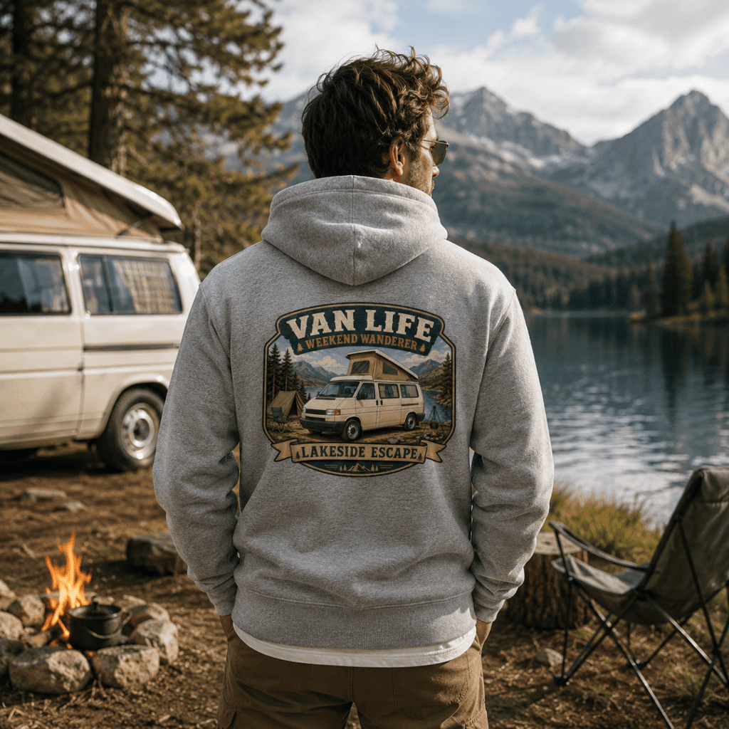 Person wearing a 'Van Life' hoodie by a lake with mountains in the background