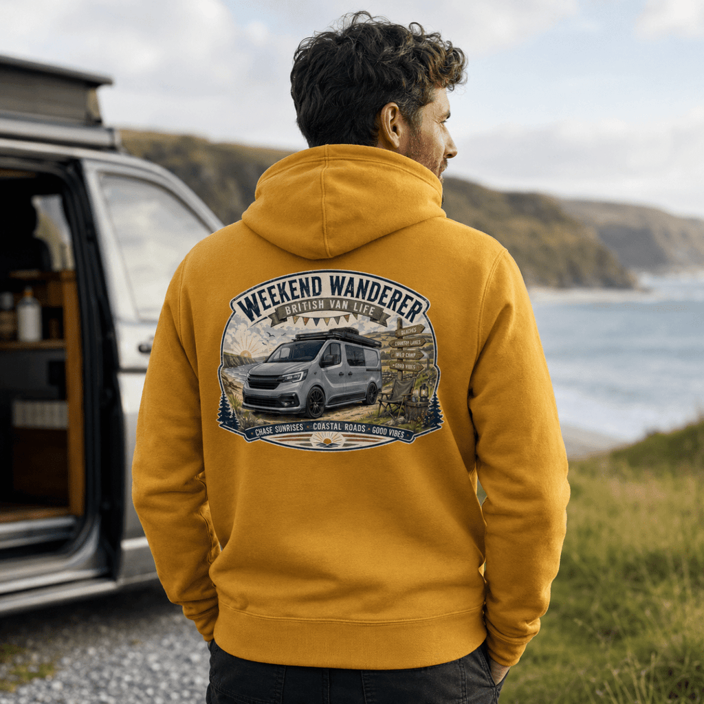 Person wearing a mustard yellow hoodie with 'Weekend Wanderer' design, standing by an open van with a scenic background.