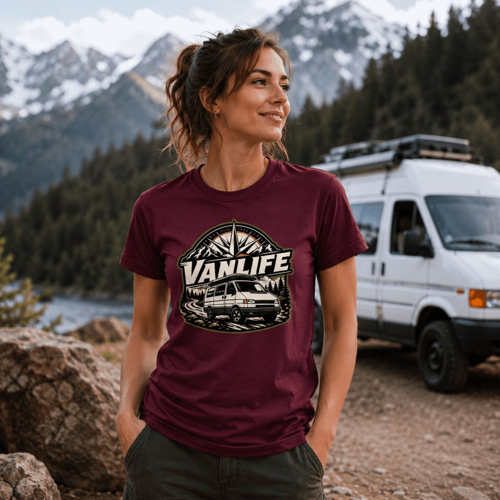 Model wearing Camberline burgundy van life t-shirt showing VanLife compass star badge with retro van and mountain forest on chest
