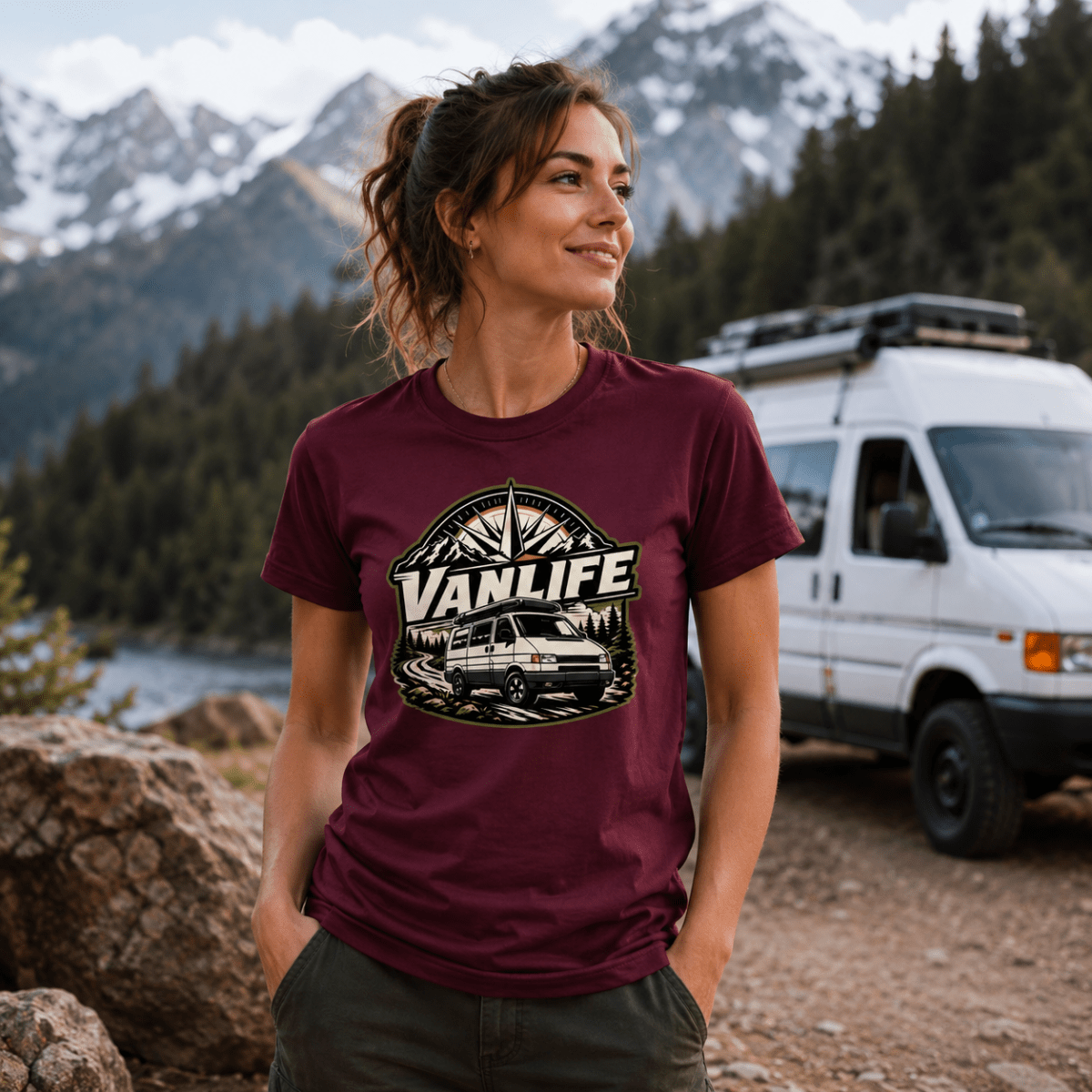 Model wearing Camberline burgundy van life t-shirt showing VanLife compass star badge with retro van and mountain forest on chest