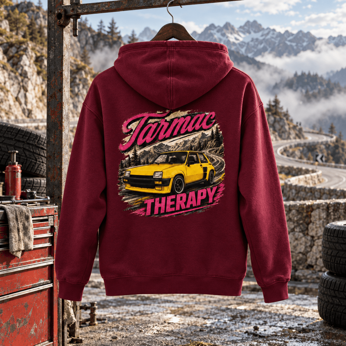 Tarmac Therapy burgundy hoodie back in a gritty mountain tyre workshop