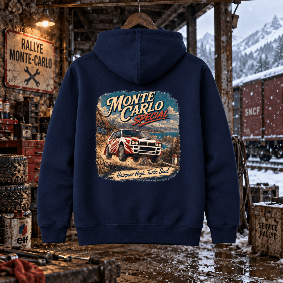 Monte Carlo Special navy hoodie back in a gritty Alpine railway rally workshop