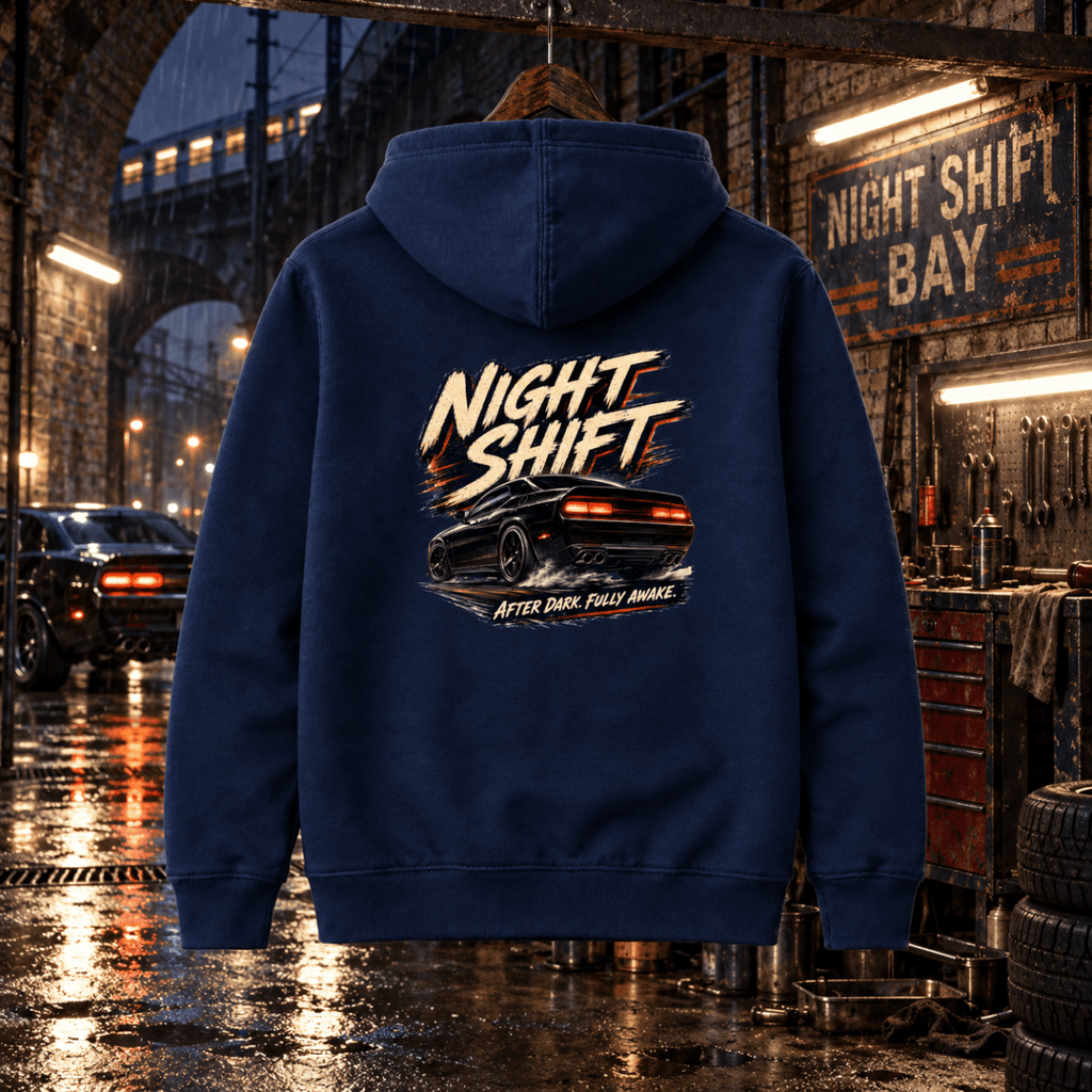 Night Shift navy hoodie back in a gritty rain-soaked railway arch garage