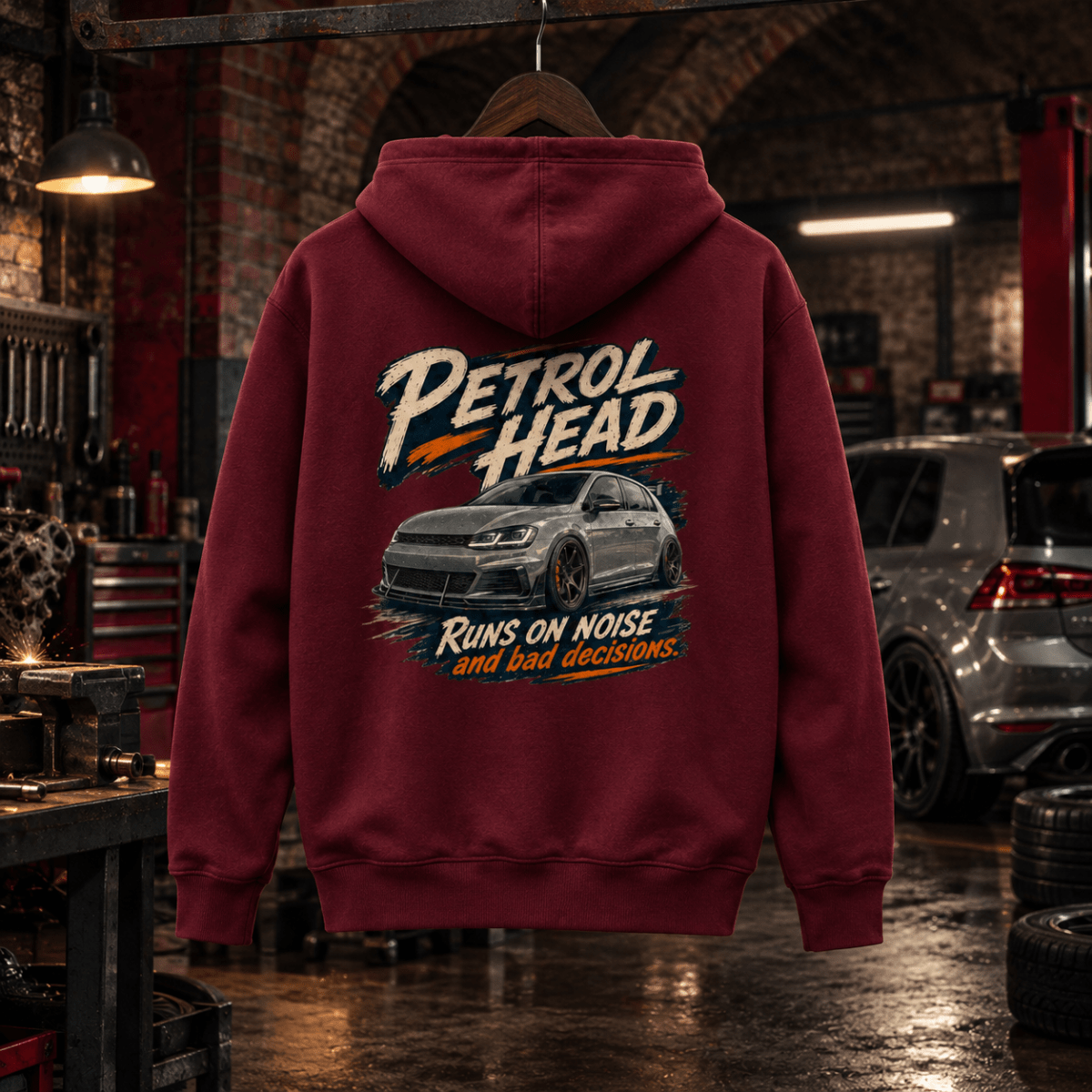 Petrol Head burgundy hot hatch hoodie back in a gritty railway arch tuning garage