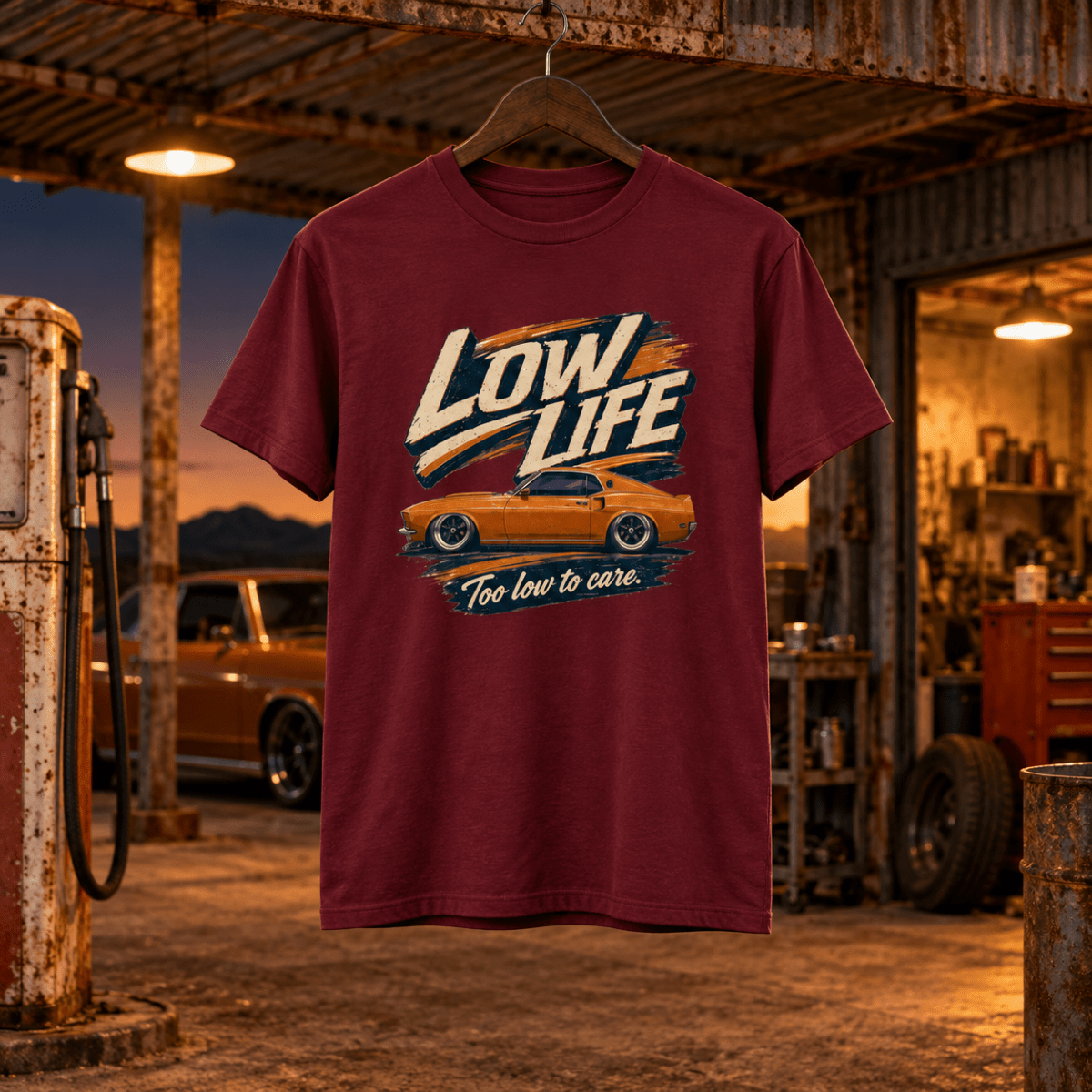 Low Life burgundy T-shirt front in a gritty desert petrol station workshop