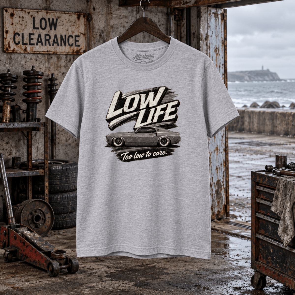 Low Life sport grey T-shirt front in a gritty seaside suspension workshop