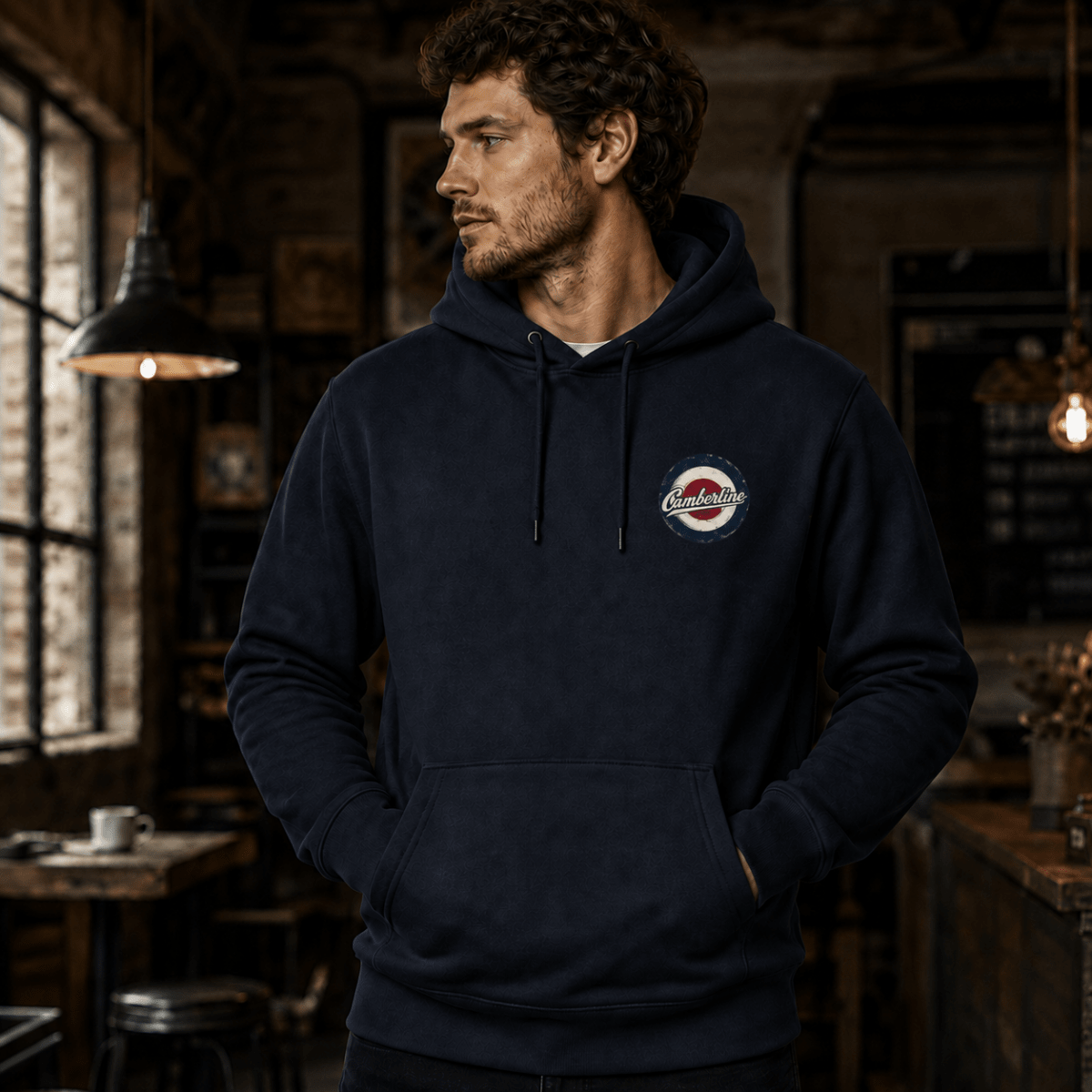 Front view of model wearing the navy Camberline hoodie with left-chest print