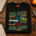 Black Eat Sleep Haul Repeat lorry T-shirt folded on a retro dispatch counter