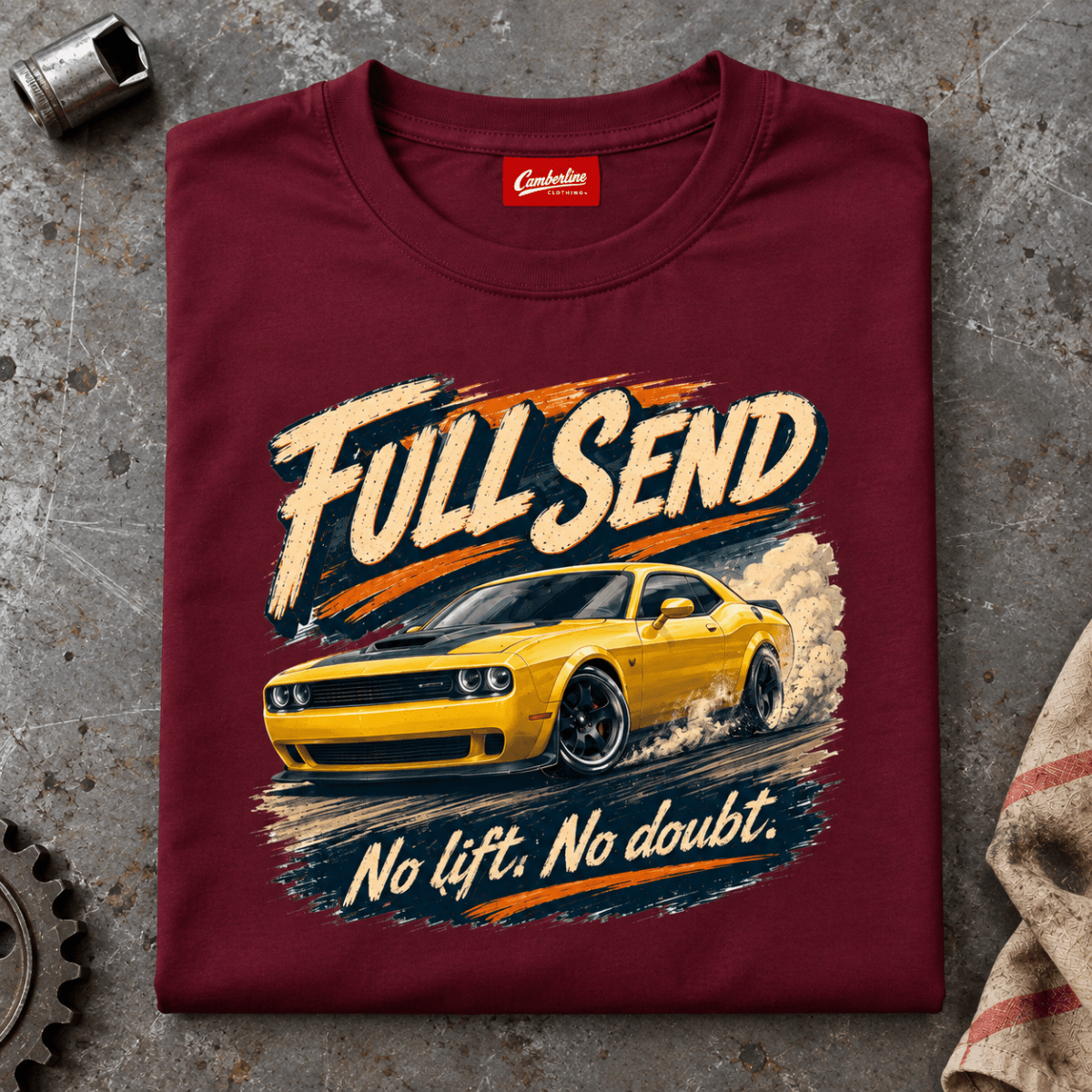 Folded maroon Full Send T-shirt front on a workshop bench — car-ts-0089