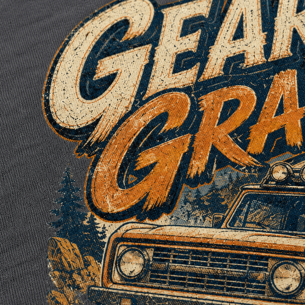 Close-up of a dark gray graphic t-shirt featuring a distressed vintage orange and cream 'Gear for Grizzlies' print with an off-road truck illustration.