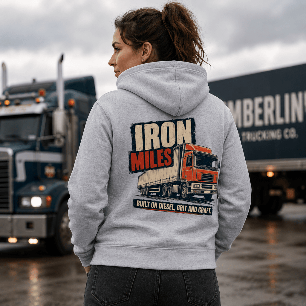 Person wearing a hoodie with a truck design and text in front of trucks