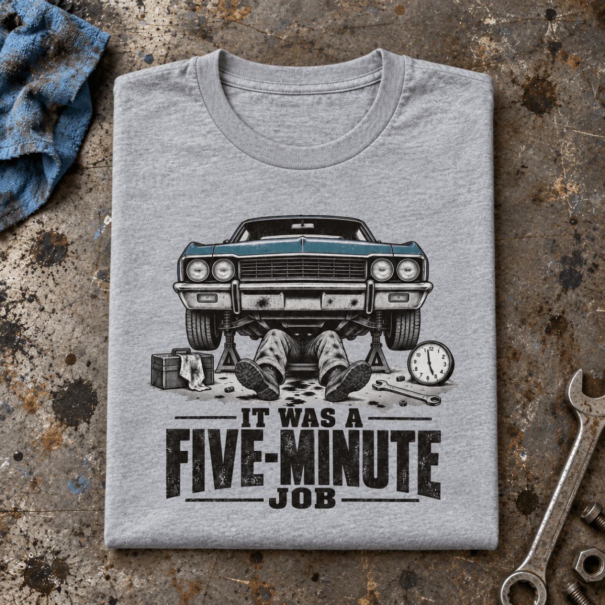Camberline Classic Car Mechanic T-Shirt in heather grey, folded front view on a workshop bench with full graphic visible