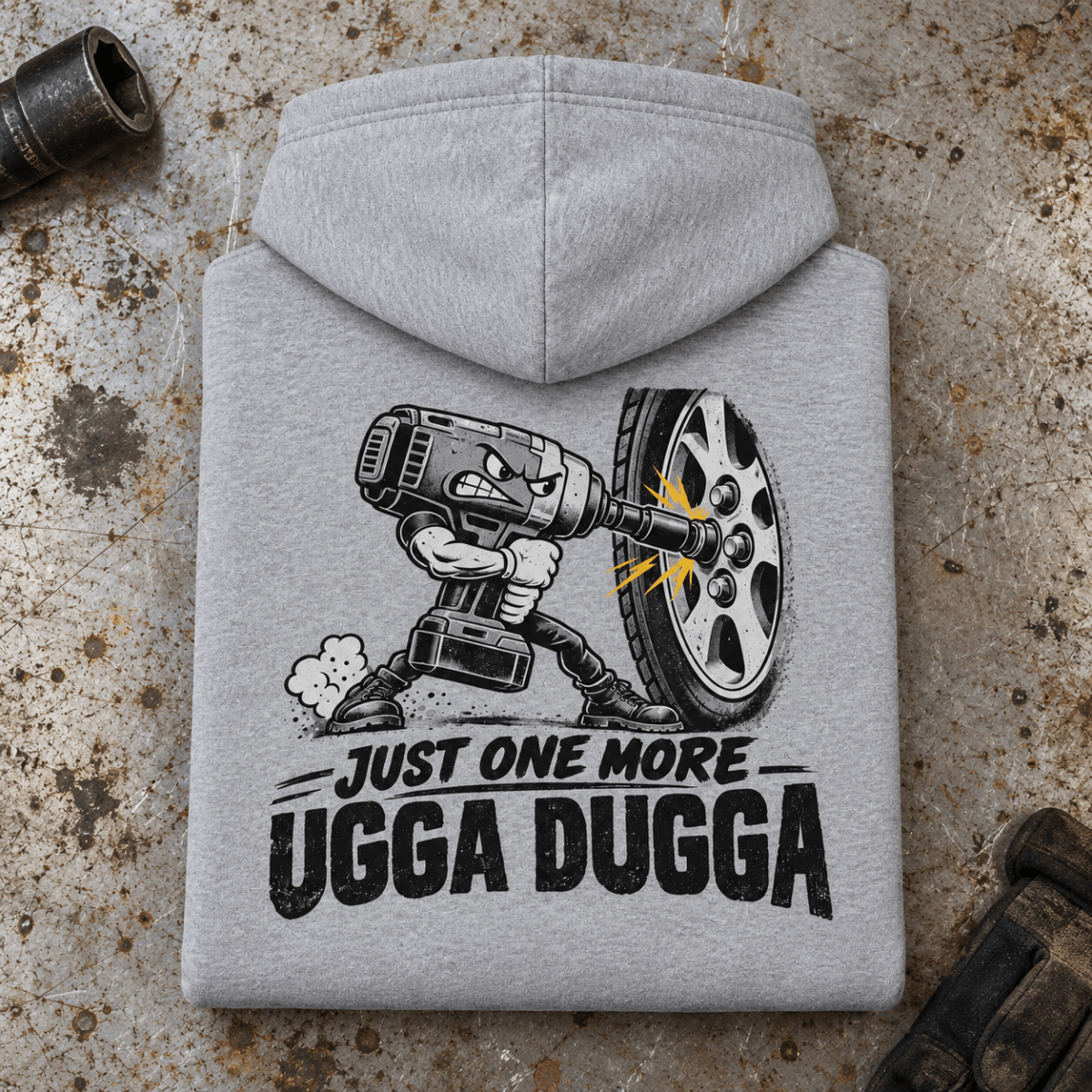 Camberline Impact Wrench Mechanic Hoodie in heather grey, folded back view on a workshop bench with full graphic visible