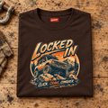 Folded dark chocolate Locked In off-road 4x4 T-shirt, front print on a rustic workshop bench — car-ts-0005