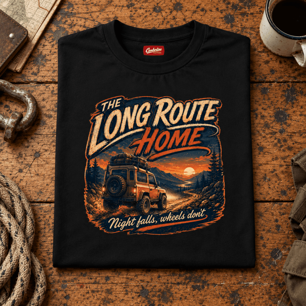 Camberline long route home 4x4 black T-shirt, folded front view on a workshop bench with the complete graphic visible.
