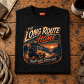 Camberline long route home 4x4 black T-shirt, folded front view on a workshop bench with the complete graphic visible.